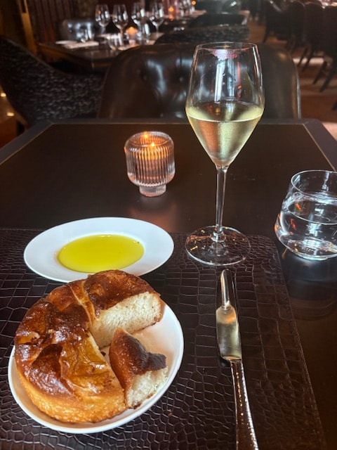Table setting at Arianna — wine, bread, and elegant service