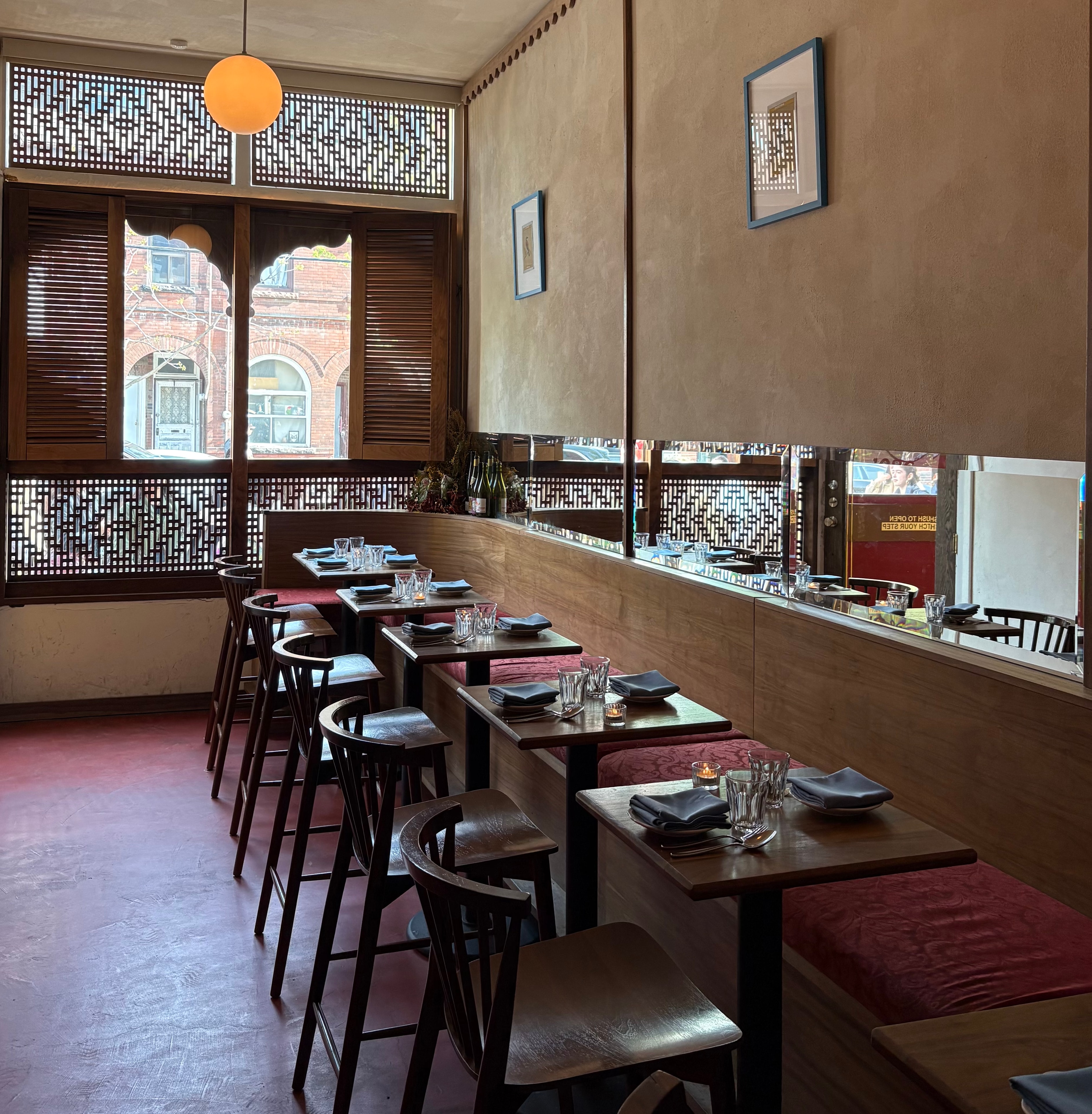 A wider view of the Jamil's Chaat House dining room — vintage Bollywood records and family photos personalise the space