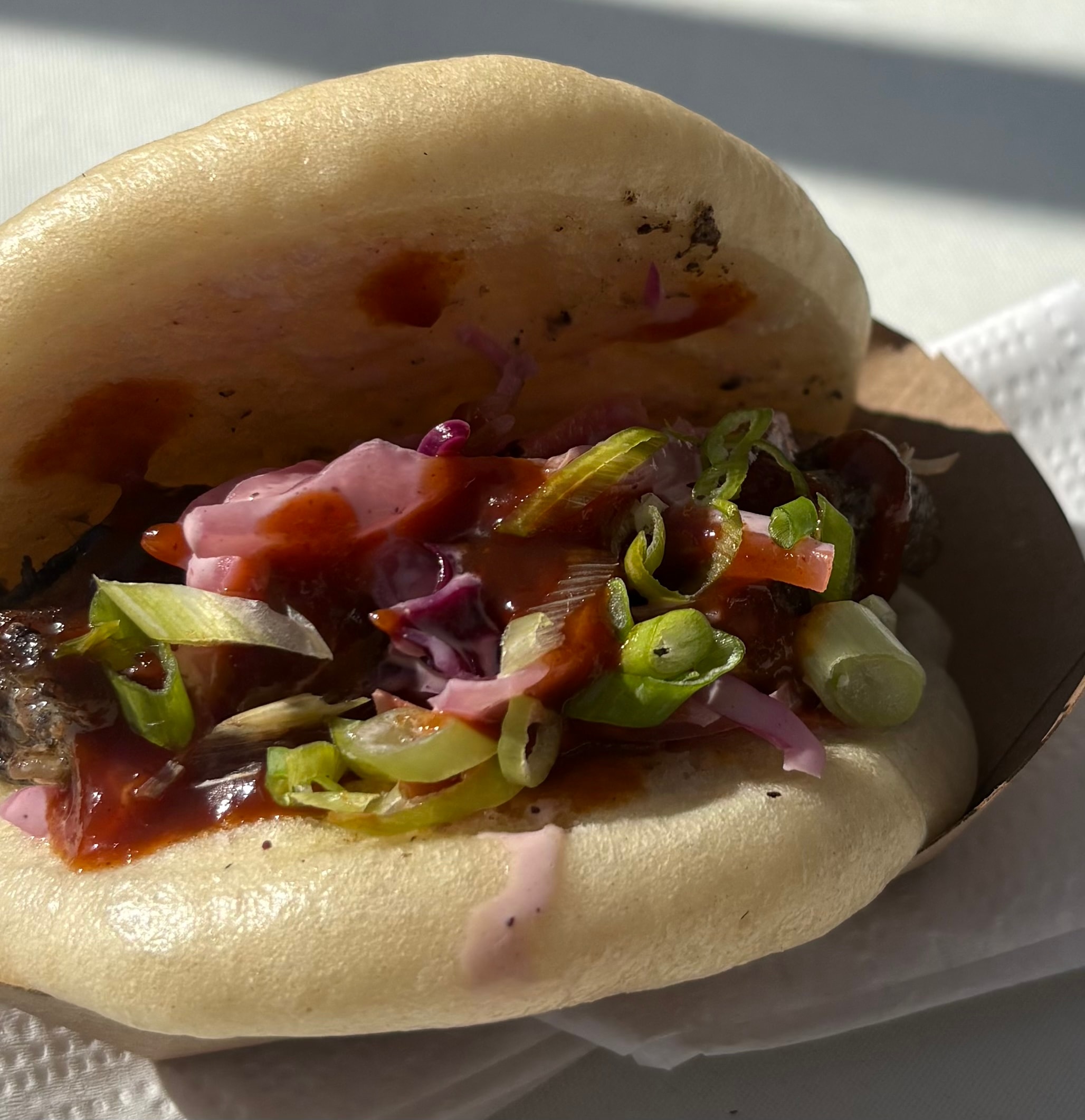 A Taste of Culture — gourmet hot dog with pickled onions